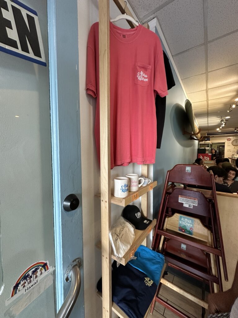 Cute merchandise like t-shirts and mugs at the entrance of Aloha Kitchen