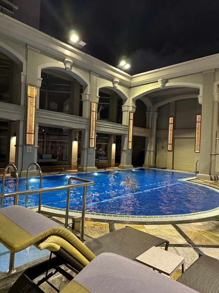 The Langham Hong Kong rooftop swimming pool and lounge area