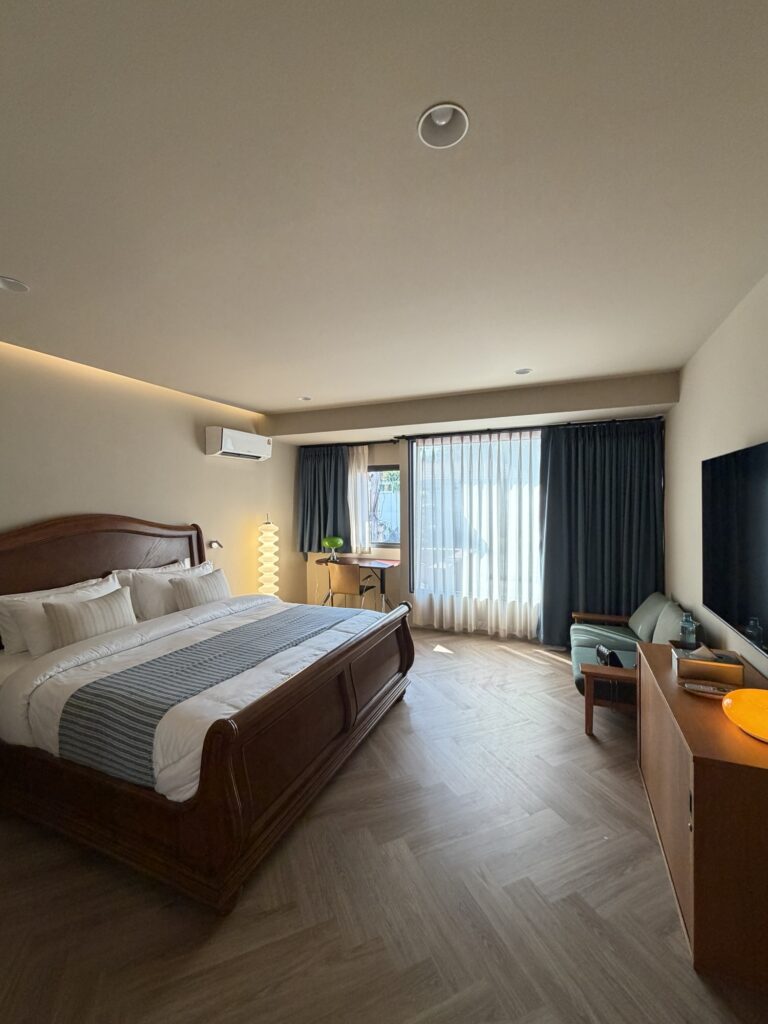 Comfortable bedroom with clean white bedding at Introvert Haus Chiang Mai.